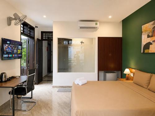 a bedroom with a bed and a desk and a computer at Unity Villa Staycation -Self Checkin in Hoi An