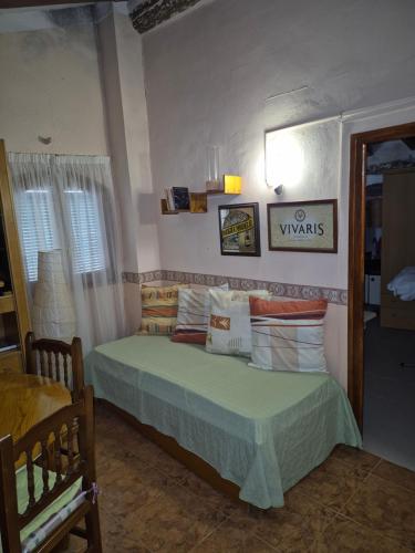 a bedroom with a bed with a green comforter and pillows at Casa Irlia in García