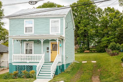 a blue house with a porch and a yellow door at Green on New in Staunton