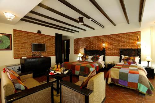 a hotel room with two beds and a tv at Hotel Heritage in Bhaktapur