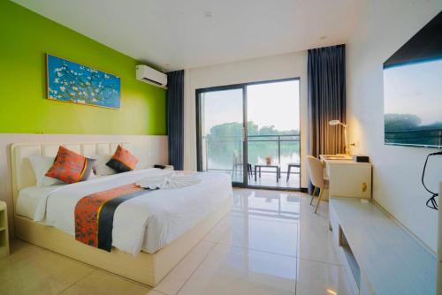 a bedroom with a large bed with a green wall at Nausori Plaza Hotel in Vunimono