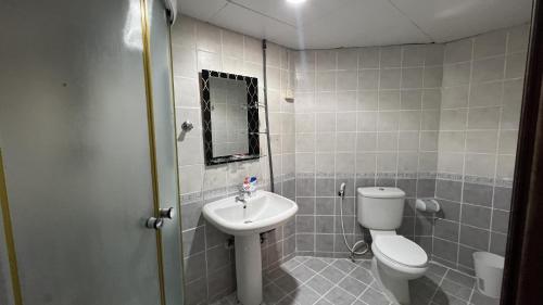 a bathroom with a toilet and a sink at Banny Homes - Cozy Suite Apartment - Downtown in Abu Dhabi