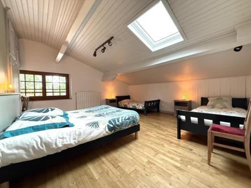 a bedroom with two beds and a skylight at Arlotia in Ascarat