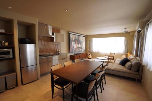 a kitchen and living room with a table and chairs at TABISAI HOTEL Premium 博多-中洲 in Fukuoka