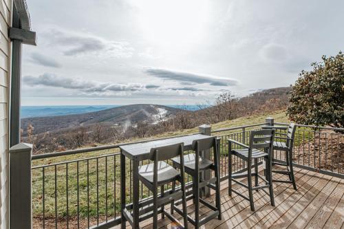 a table and chairs on a balcony with a view at Mountain View Vista in Mount Torry Furnace
