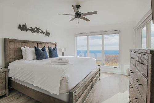 a bedroom with a large bed with a ceiling fan at Mountain View Vista in Mount Torry Furnace