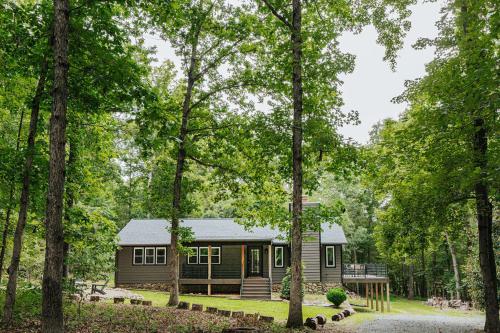 a small cabin in the woods with trees at Nelson Cozy Cabin in Nellysford