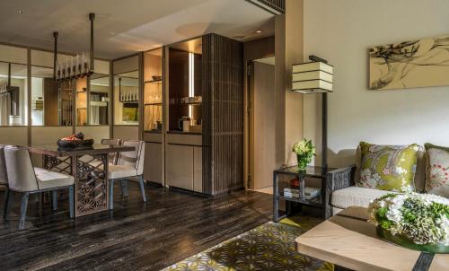 a living room with a couch and a table at Four Seasons Hotel Kyoto in Kyoto