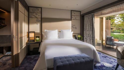 a bedroom with a large bed and a patio at Four Seasons Hotel Kyoto in Kyoto