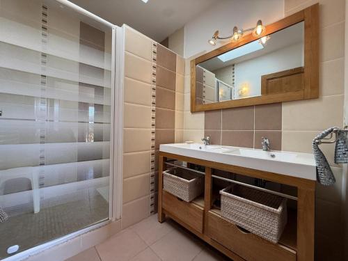 a bathroom with a sink and a mirror and a shower at Juanttipienea in Souraïde