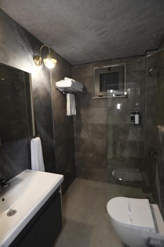 a bathroom with a shower and a toilet and a sink at Italy hotel in Silifke