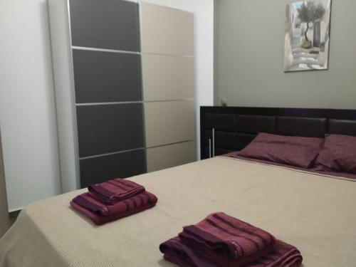 two towels sitting on a bed in a bedroom at Nova Ledeza NL II in Igoumenitsa