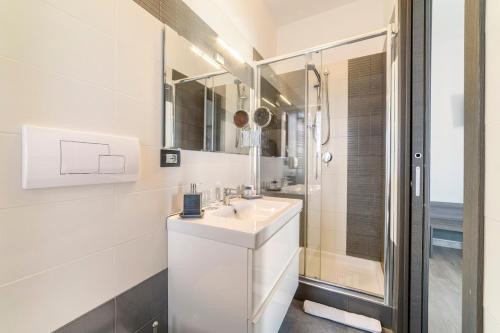 a white bathroom with a sink and a shower at 85Centro in Potenza