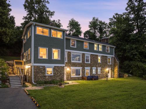 a home with a black house on a lawn at Swannanoa Guest House in Afton