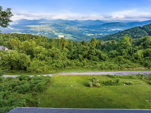 an aerial view of a field with a river and mountains at Swannanoa Guest House in Afton