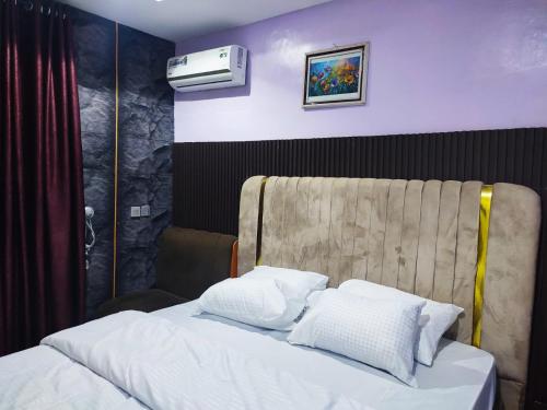 a bedroom with a bed and a air conditioner at Regent Hotels and Suites in Oshogbo