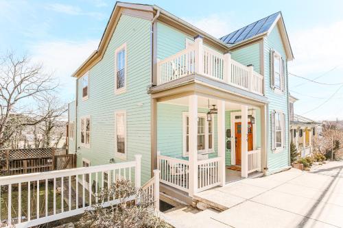 a blue house with a white fence at The Hunker Down in Staunton