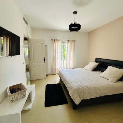 a bedroom with a large bed and a window at Villa Sunlight Mougins in Mougins