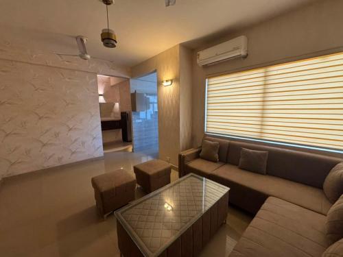 a living room with a couch and a table at Pindora Stays in Ludhiana