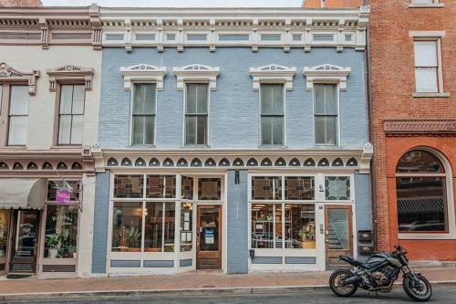 a motorcycle parked in front of a blue building at The Social Loft in Staunton