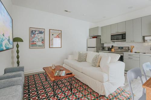 a living room with a white couch and a table at The Social Loft in Staunton