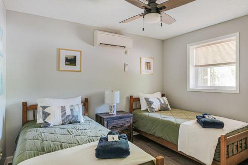 a bedroom with two beds and a ceiling fan at Tucked Inn: Lower Unit in Nellysford