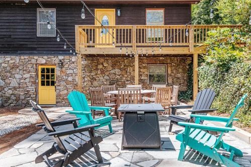 a patio with chairs and a table and a deck at Tucked Inn: Lower Unit in Nellysford