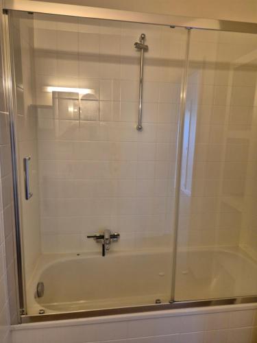 a bathroom with a shower with a bath tub at Sealview Nevada in Koksijde