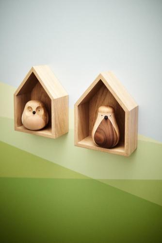 two wooden bird houses with faces and a vase at Hotel Zugbrücke Grenzau GmbH in Höhr-Grenzhausen