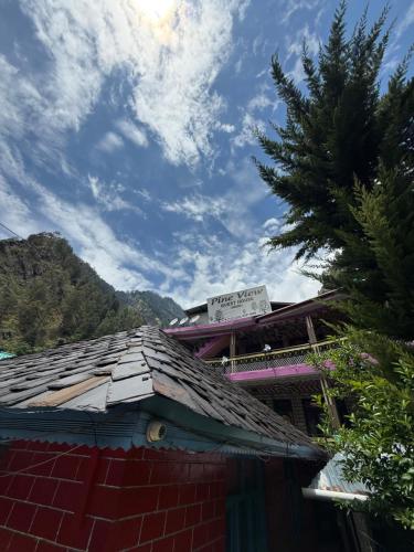 a roof of a building with a sign on it at Pine View By Wonderhill in Manīkaran