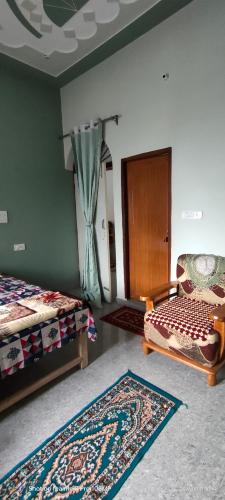 a bedroom with two beds and a rug on the floor at Rawat Homestay in Rishīkesh