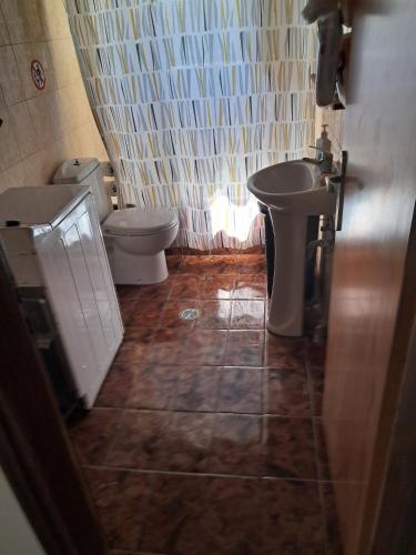 a bathroom with a sink and a toilet at Galinis Rooms in Paradeísion