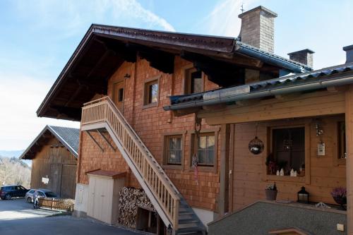 a wooden house with a staircase in front of it at Hohe Tauernblick in Mittersill