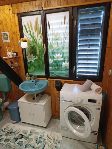 a bathroom with a washing machine and a sink at Apartman "SaraP" Metković in Metković