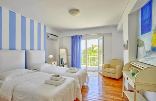 a white bedroom with two beds and a piano at Villa Helios Corfu Kassiopi in Kassiopi
