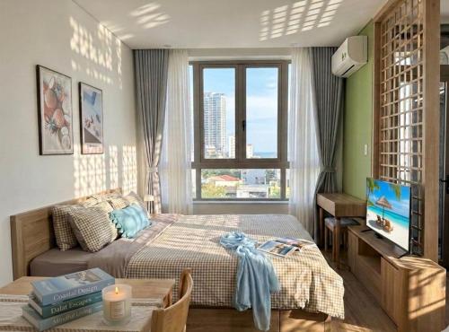 a bedroom with a bed and a window at Seaflow Staycation in Danang