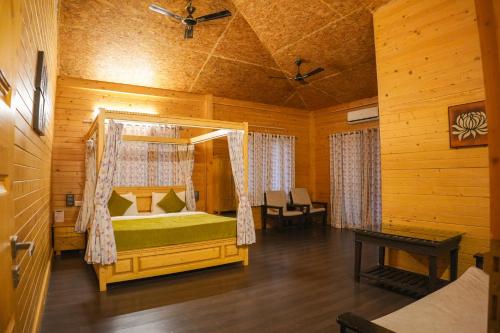a bedroom with a bed in a wooden room at White Petals Resort in Bangalore