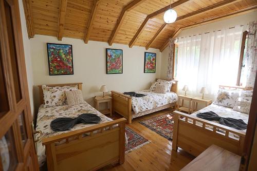 a bedroom with two beds and a window at Kulla e Andrrave in Ducaj