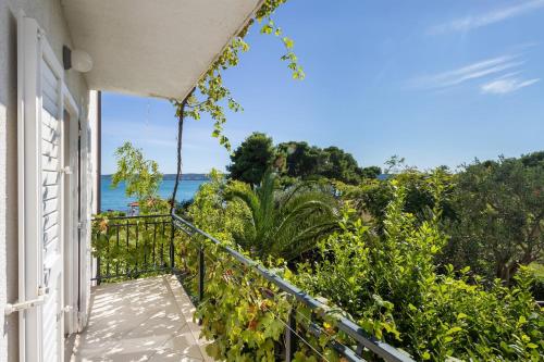 a balcony with a view of the ocean at Hostel Oktarin in Kaštela
