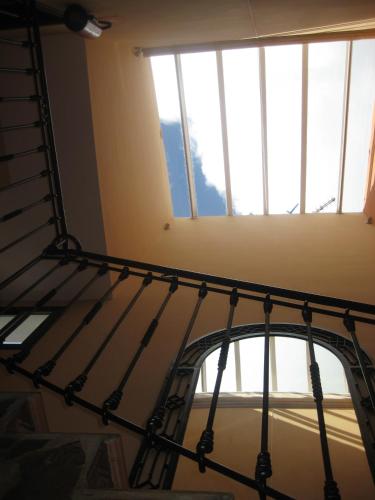 a spiral staircase in a room with windows at Alojamientos Rurales Los Molinos in Fuentes de León