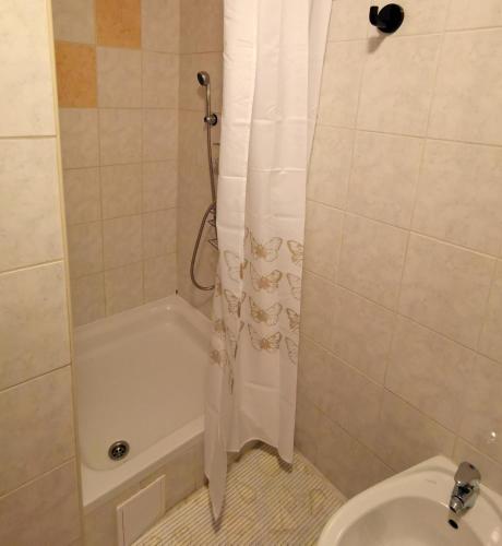 a bathroom with a shower curtain and a toilet at Mali raj in Stara Novalja