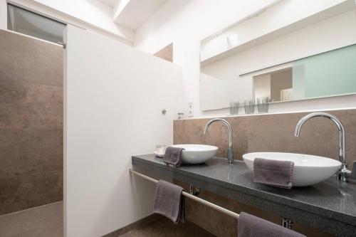 a bathroom with two sinks on a counter at eifel5starIV Burgfriedstraße in Daun