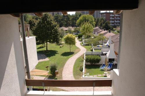 a view of a park from a balcony of a building at Villaggio Los Nidos in Lignano Sabbiadoro