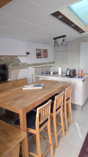 a kitchen with a wooden table and chairs at Gästenzimmer Louis in Ediger-Eller