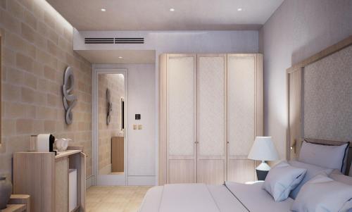 a bedroom with a white bed and a closet at Casa Azure Meliá Collection in San Lawrenz