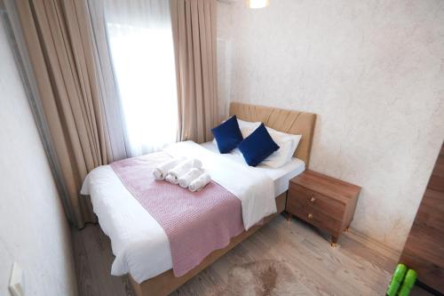 a bedroom with a bed with two stuffed animals on it at Classic Suite MK1 in Istanbul
