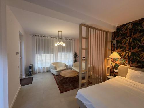 a bedroom with a bed and a living room at Lucas 10 Apartments in Cluj-Napoca