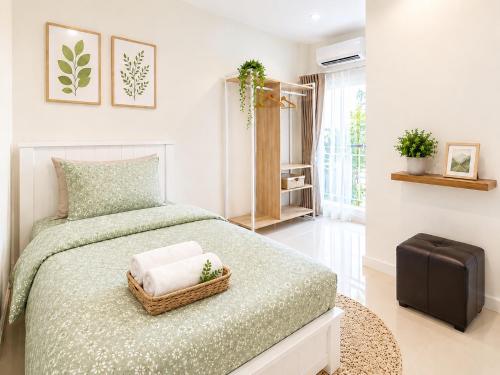 a bedroom with a bed and a suitcase in it at Urban Homie 40 in Langu
