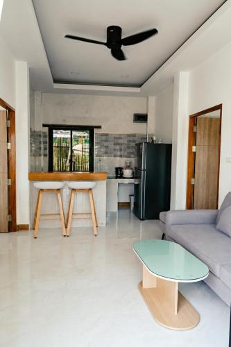 a living room with a couch and a table at Garden Villa in Srithanu