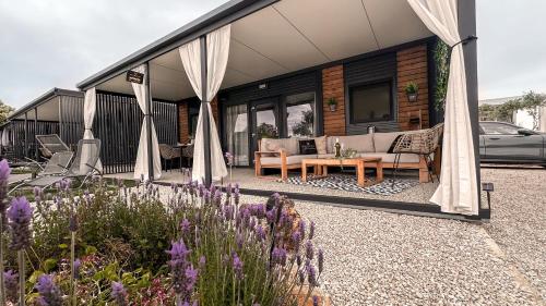 a house with a patio with a couch and a table at Ausblick Sunce i More Mobilehome in Pirovac